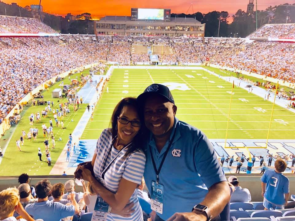 Tony Kearney with a friend at Kenan Stadium during a football game.